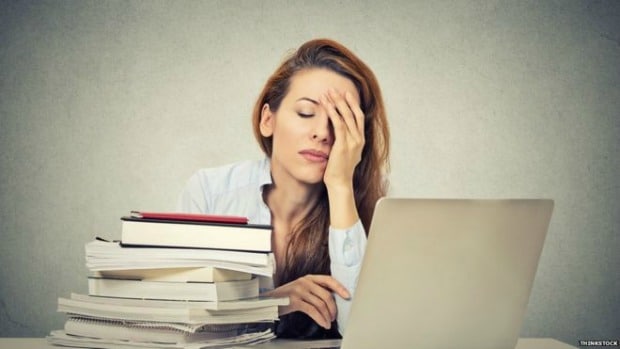 Woman stressed out in front of laptop