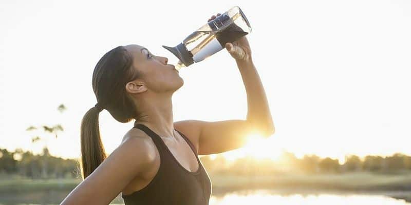 Woman working out and drinking water