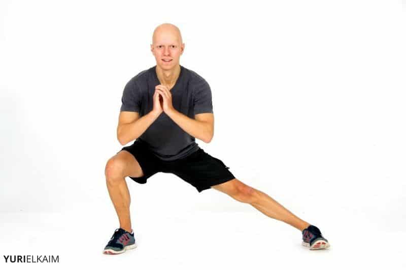 Premium Photo  Sportsman hold lunge position doing stretch routine after  outdoor athletic workout on promenade stretching