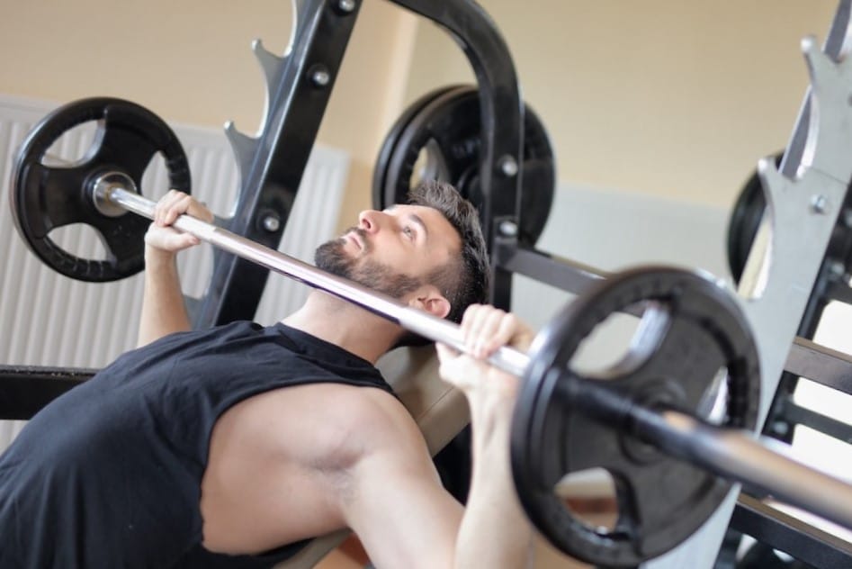 Image of a man doing the incline bench press using a barbell from Pexels.