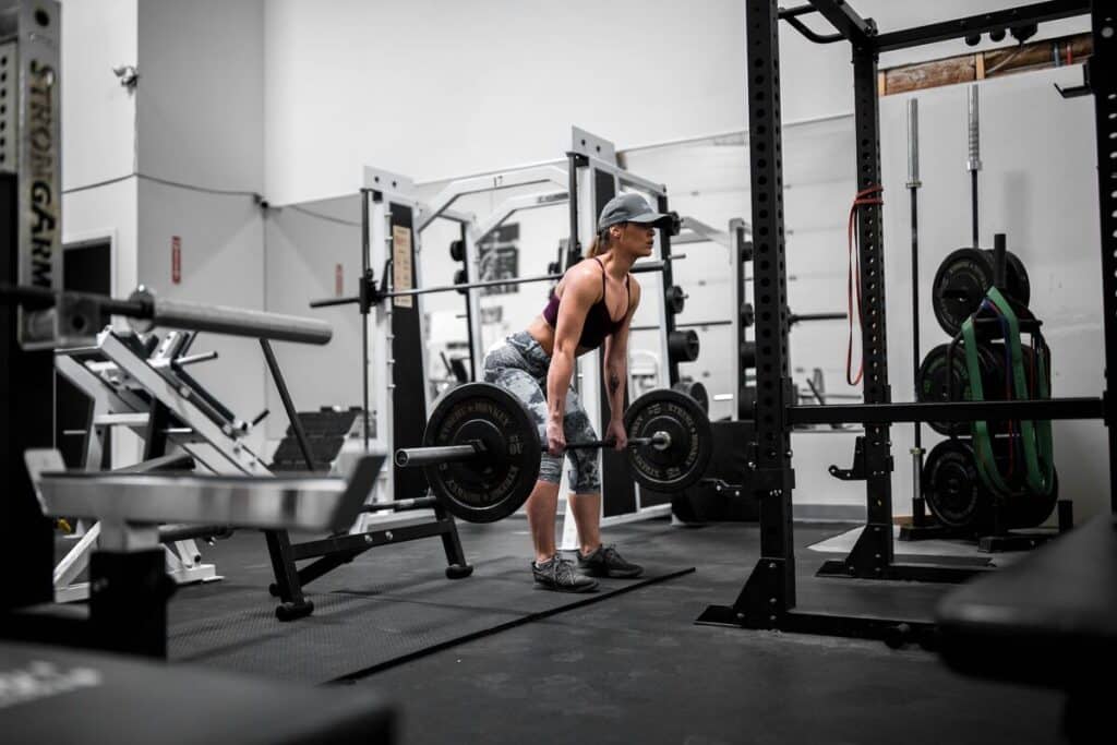 Image of a woman doing a deadlift. Source: Unsplash