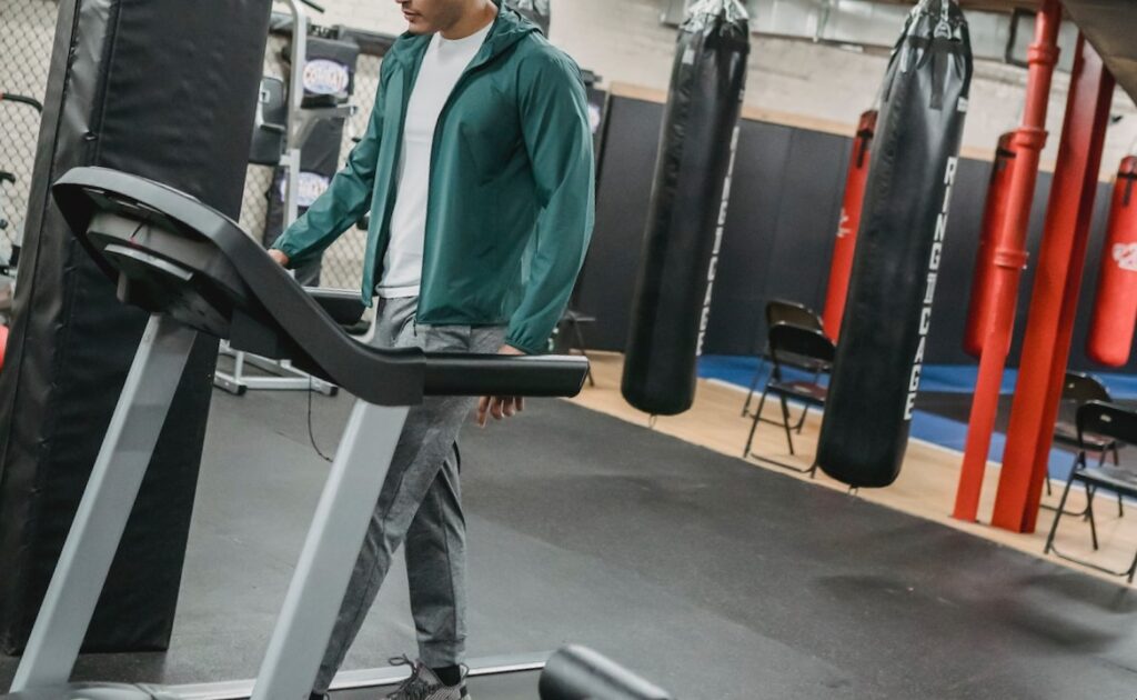 Image of a man working out on an incline treadmill.