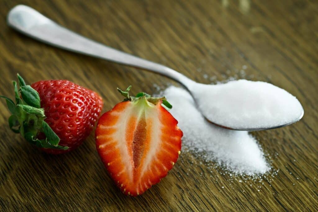 Image of strawberries and a spoon full of sugar. Image source: Pexels