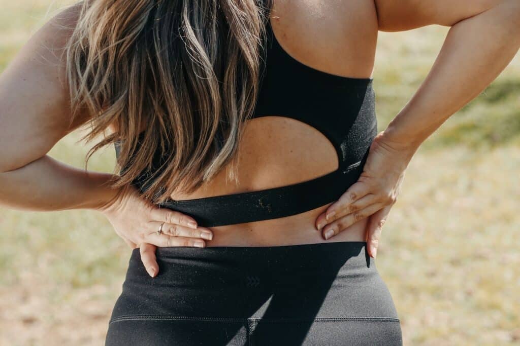 Image of a woman streching her lower back. Source: Pexels - Effective Exercises for Pinched Nerve in Lower Back
