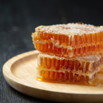 fresh honeycombs on dark wooden surface. Image source: freepik