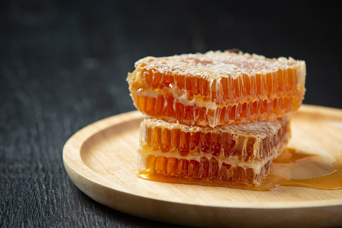 fresh honeycombs on dark wooden surface. Image source: freepik