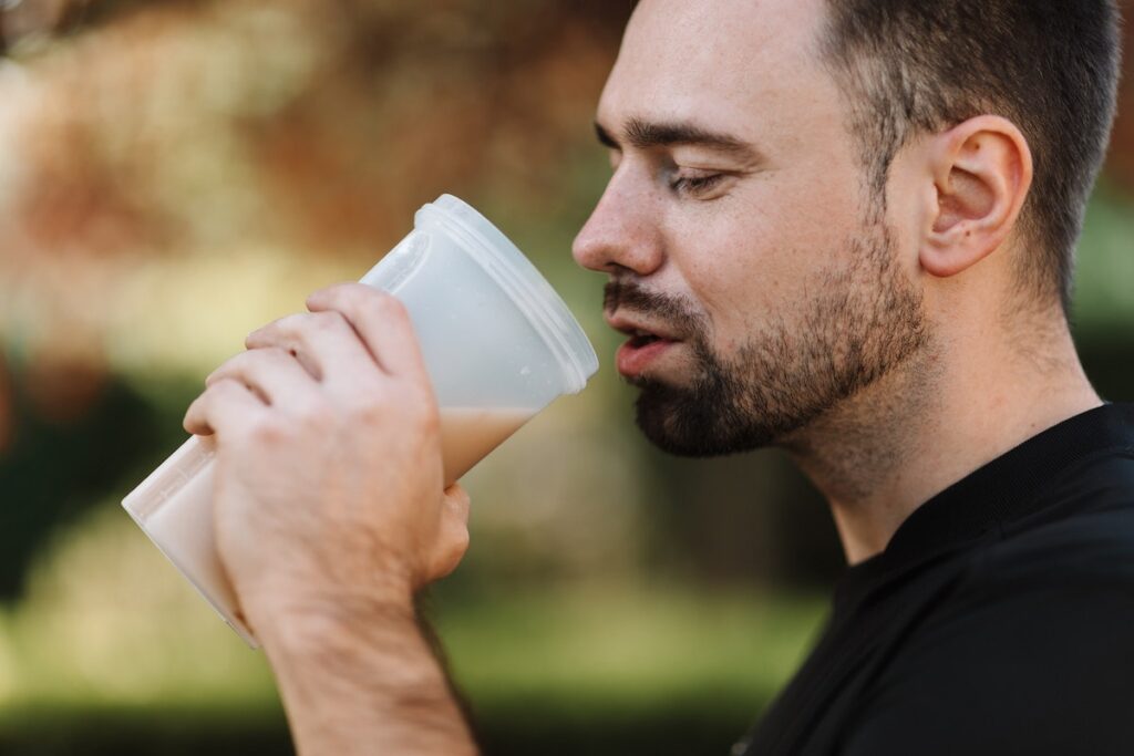 Image of a man drinking a protein shake. Source: Pexels