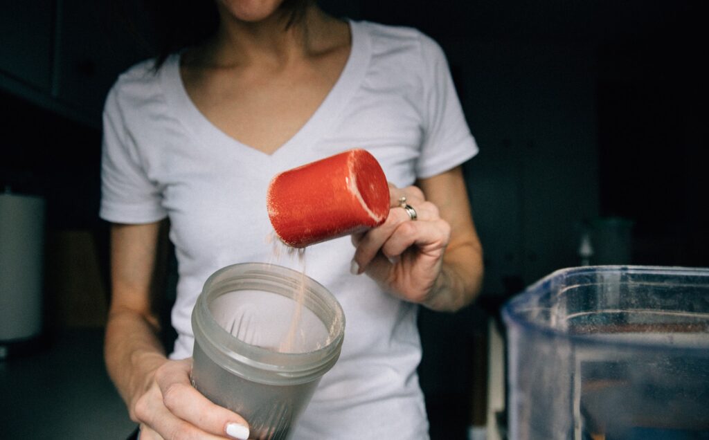 Image of a person preparing a protein shake. Source: Pexels - 8 Best Milk Options for Protein Shakes