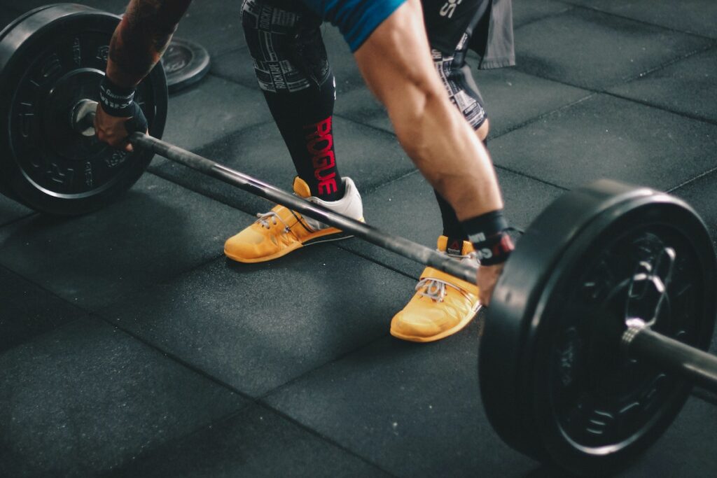 Image of a weightlifter lifting a barbell at the gym. Source: Pexels