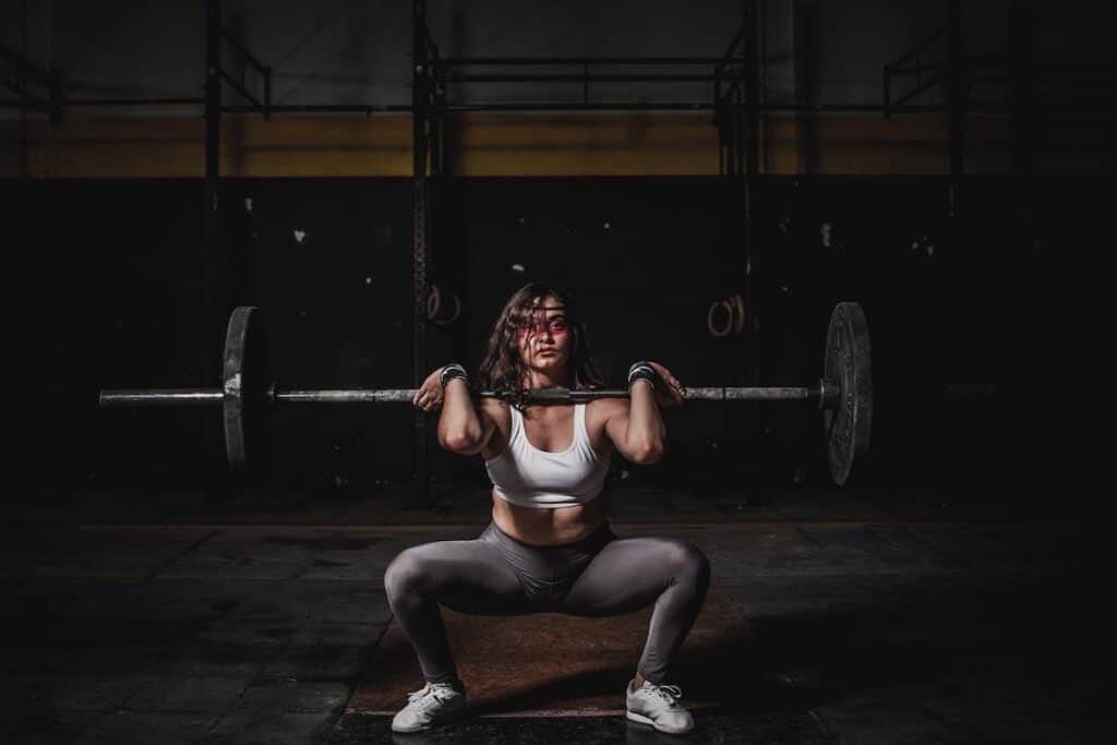 Image of a woman doing front squats with weights. Source: Pexels