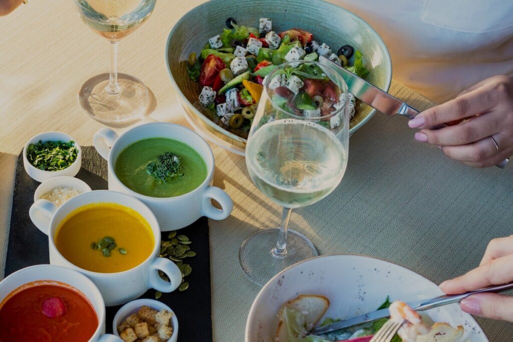 Image of people eating healthy meals at a dinner table. Unsplash