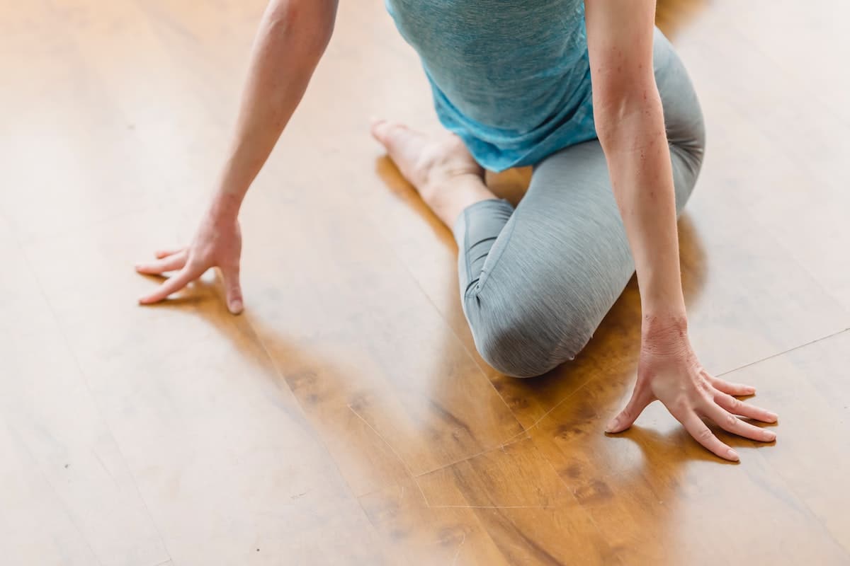 Image of a woman stretching her hips. Source: Pexels