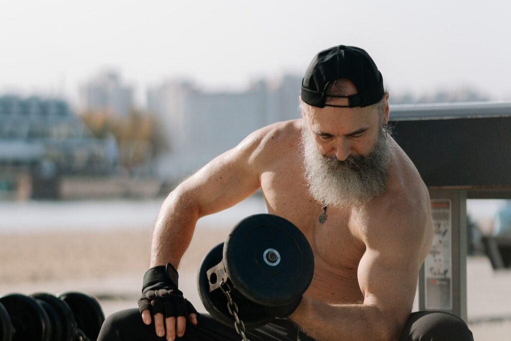 Image of an old man lifting a dumbbell.  pexels- Building Muscle After 50 Made Simple: Defying Aging with Strength