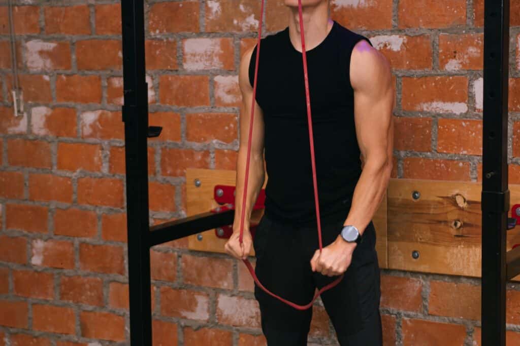 Image of a man doing vertical pull down with a resistance band. Source: Pexels - 11 Killer Back Workouts With Resistance Bands (No Weights Needed)