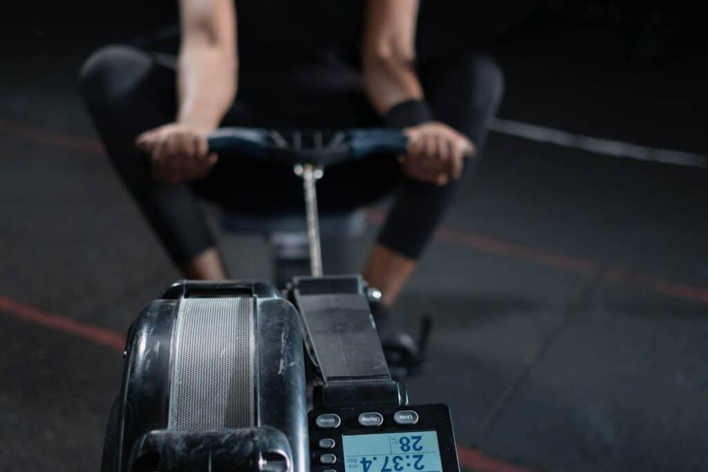 Image of a man working out with a rowing machine. Source: Pexels
