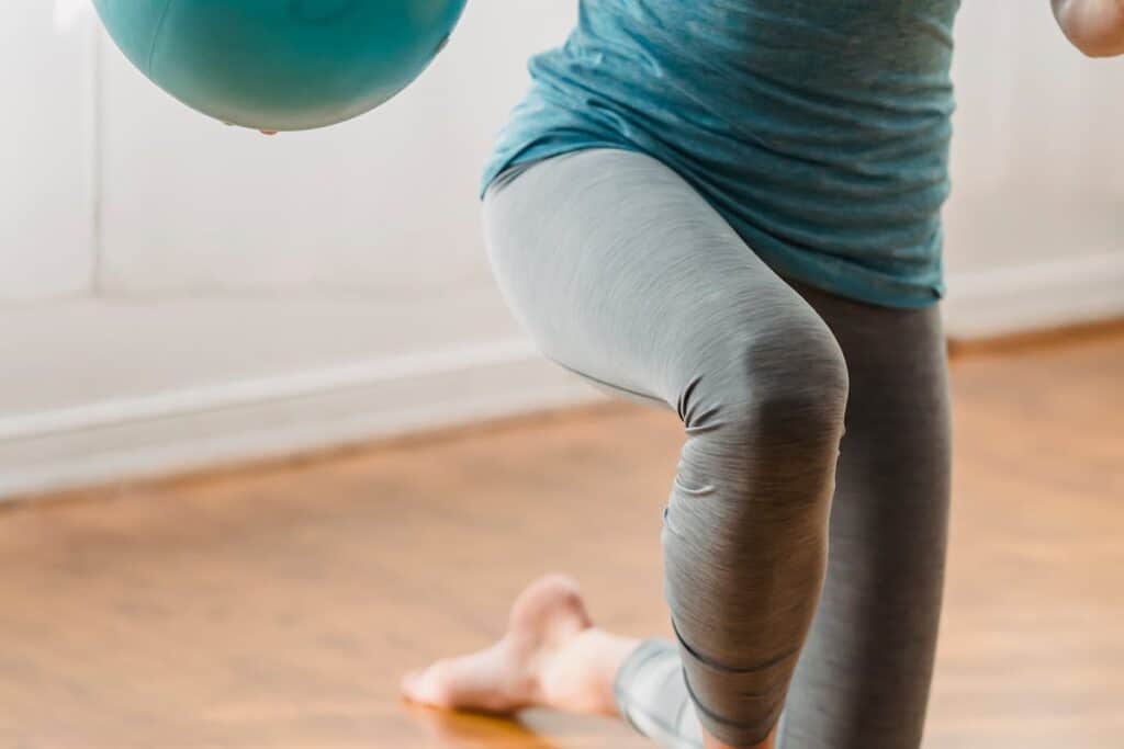 Image of a woman doing lunges, one of the best squat alternatives for bad knees. Source: Pexels