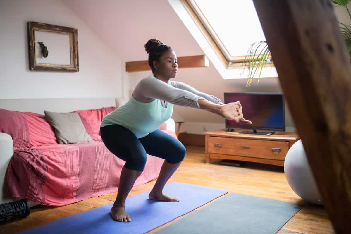 Image of a woman exercising at home, Pexels