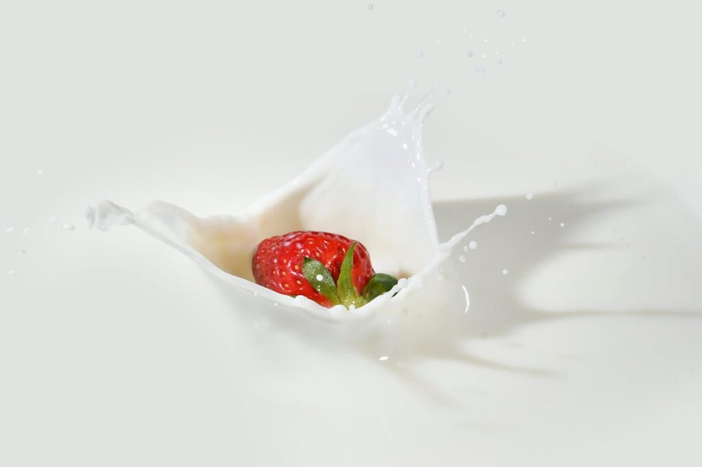 Image of strawberry dipped in milk. Source: Pexels